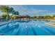 Relaxing community pool with swim lanes reflecting surrounding desert landscape and clear blue sky at 6827 E Eagle Feather Rd, Scottsdale, AZ 85266