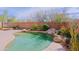 Pool with waterfall surrounded by desert landscaping at 6827 E Eagle Feather Rd, Scottsdale, AZ 85266