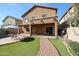 Inviting backyard with a pool, patio, artificial turf, and a charming brick pathway at 10037 W Chipman Rd, Tolleson, AZ 85353