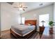Bedroom features hardwood floors, natural light, and a ceiling fan at 10037 W Chipman Rd, Tolleson, AZ 85353