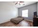 Cozy bedroom features a window and a gray accent wall at 10037 W Chipman Rd, Tolleson, AZ 85353