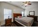 Bedroom features hardwood floors, natural light, and a ceiling fan at 10037 W Chipman Rd, Tolleson, AZ 85353