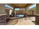 Relaxing covered patio featuring tiled floors and a table with chairs for outdoor dining at 10037 W Chipman Rd, Tolleson, AZ 85353
