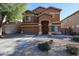 Inviting two-story home showcasing front yard landscaping and attached garage at 10037 W Chipman Rd, Tolleson, AZ 85353