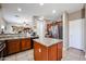 Well-lit kitchen featuring granite countertops, tile floors, and stainless steel appliances at 10037 W Chipman Rd, Tolleson, AZ 85353