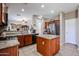 Well-lit kitchen with a convenient island, stainless steel refrigerator, and plenty of cabinet storage at 10037 W Chipman Rd, Tolleson, AZ 85353