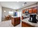Bright kitchen with an island, stainless steel appliances, and an adjacent dining area for easy meals at 10037 W Chipman Rd, Tolleson, AZ 85353