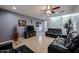Inviting living area boasts comfortable leather couches, a ceiling fan, and access to the staircase at 10037 W Chipman Rd, Tolleson, AZ 85353