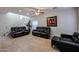 Living room featuring comfortable seating, a ceiling fan, and a staircase leading to the second floor at 10037 W Chipman Rd, Tolleson, AZ 85353