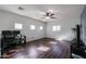 Spacious room with modern flooring, a ceiling fan, and multiple windows providing plenty of natural light at 10037 W Chipman Rd, Tolleson, AZ 85353