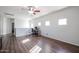Open office with hardwood floors, light walls, and three windows bringing in natural light at 10037 W Chipman Rd, Tolleson, AZ 85353