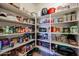 Spacious walk-in pantry with ample shelving for organized storage of food and household items at 10037 W Chipman Rd, Tolleson, AZ 85353