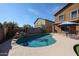 Sparkling pool with rock waterfall, surrounded by desert landscaping and a spacious patio at 10037 W Chipman Rd, Tolleson, AZ 85353