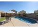 Inviting pool area with rock waterfall feature, desert landscaping, and outdoor seating at 10037 W Chipman Rd, Tolleson, AZ 85353