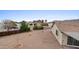 Aerial view of gravel backyard showcasing mature landscaping and neighborhood views at 10241 E La Palma Ave, Gold Canyon, AZ 85118