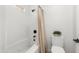 Clean white bathroom with a tub and shower combination and white tiles at 10241 E La Palma Ave, Gold Canyon, AZ 85118