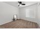 Cozy bedroom offers neutral carpet, a ceiling fan, and large window at 10241 E La Palma Ave, Gold Canyon, AZ 85118