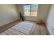 Cozy bedroom featuring hardwood floors, neutral walls, and a large window showcasing neighborhood view at 10241 E La Palma Ave, Gold Canyon, AZ 85118