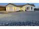 Charming single-story home featuring a two-car garage and low-maintenance desert landscaping at 10241 E La Palma Ave, Gold Canyon, AZ 85118