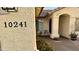Up-close view highlighting the home's address, cozy front patio seating, and well-kept landscaping at 10241 E La Palma Ave, Gold Canyon, AZ 85118