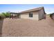 Exterior view of home with covered patio, gravel landscaping, and a well-maintained facade at 10241 E La Palma Ave, Gold Canyon, AZ 85118