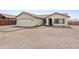 Well-maintained single-story home with a low maintenance desert landscaped front yard and attached two-car garage at 10241 E La Palma Ave, Gold Canyon, AZ 85118