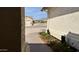 A glimpse of the home's exterior showcases well-maintained landscaping, a walkway, and mountain views at 10241 E La Palma Ave, Gold Canyon, AZ 85118