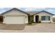 Charming single-story home featuring a stucco facade, tile roof, and a low-maintenance rock yard at 10241 E La Palma Ave, Gold Canyon, AZ 85118