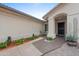Inviting front porch with seating area, lush desert plants, and a decorative bear statue at 10241 E La Palma Ave, Gold Canyon, AZ 85118