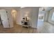 A hallway scene with modern flooring and an elegant side table with view to the outdoor space at 10241 E La Palma Ave, Gold Canyon, AZ 85118