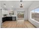 Open kitchen and dining area featuring modern white cabinets and stainless steel appliances at 10241 E La Palma Ave, Gold Canyon, AZ 85118