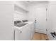 Bright laundry room with modern washer and dryer and convenient shelving at 10241 E La Palma Ave, Gold Canyon, AZ 85118