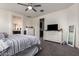 Bedroom with plush carpet, white walls, and views into the bathroom and closet at 10454 W Maya Way, Peoria, AZ 85383