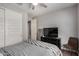 Comfortable bedroom featuring carpeted floors, ample closet space, and a modern TV for entertainment at 10454 W Maya Way, Peoria, AZ 85383