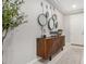 Stylish entryway with a wood console table, round mirrors, and decorative accents at 10454 W Maya Way, Peoria, AZ 85383