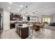 Open kitchen flows into dining area with a large island and modern stainless appliances at 10454 W Maya Way, Peoria, AZ 85383