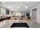 Open concept kitchen with granite countertops, pendant lights, and open access to the dining and living area at 10454 W Maya Way, Peoria, AZ 85383