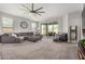 Comfortable living room with a large sectional sofa and sliding glass doors to the patio at 10454 W Maya Way, Peoria, AZ 85383