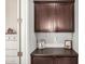 Mud room area with wood cabinets, countertop, and ample storage, providing a practical transition space at 10454 W Maya Way, Peoria, AZ 85383