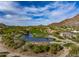 Expansive aerial view of the golf course and surrounding homes in the desert community, with stunning rock formations at 10596 E Yearling Dr, Scottsdale, AZ 85255