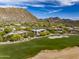 Picturesque aerial shot of golf course home nestled within rocky desert landscape, showcasing the community at 10596 E Yearling Dr, Scottsdale, AZ 85255