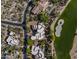 Aerial view of an estate home with a pool, surrounded by desert landscaping and a golf course at 10596 E Yearling Dr, Scottsdale, AZ 85255