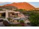 Scenic backyard with a pool, spa, lush landscaping, and mountain views, perfect for outdoor living at 10596 E Yearling Dr, Scottsdale, AZ 85255