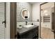Stylish powder room with decorative wallpaper, modern sink, and unique lighting at 10596 E Yearling Dr, Scottsdale, AZ 85255