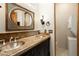 Bathroom with double vanity, decorative mirrors, granite countertops and in unit washer and dryer at 10596 E Yearling Dr, Scottsdale, AZ 85255
