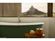 Elegant bathroom with a freestanding tub and a window framing a scenic mountain view at 10596 E Yearling Dr, Scottsdale, AZ 85255