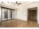 A spacious bedroom with hardwood floors and glass doors leading to the patio at 10596 E Yearling Dr, Scottsdale, AZ 85255