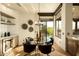 Elegant dining area with stylish lighting, a modern table, and access to outdoor living spaces and pool at 10596 E Yearling Dr, Scottsdale, AZ 85255