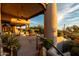 Exterior shot of the home shows the outdoor living space with seating and lush desert landscaping at 10596 E Yearling Dr, Scottsdale, AZ 85255