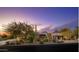 Desert home with desert landscaping in front, and views of the mountains in the distance at 10596 E Yearling Dr, Scottsdale, AZ 85255
